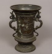 A Chinese patinated bronze vase Of flared form, with twin dragon form handles,