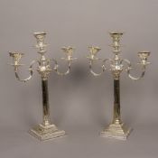 A pair of silver plated three branch candelabra Each of Corinthian column form. Each 47 cm high.