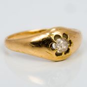 An unmarked gold gypsy set diamond solitaire ring The stone approximately 0.25 of a carat.