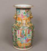 A 19th century Canton famille rose porcelain vase The flared neck with twin dog-of-fo handles above