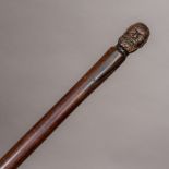 A 19th century carved rosewood walking stick The finial formed as the bust of a bearded man.