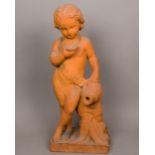 A terracotta sculpture modelled as a young child holding an amphora and a bowl Wearing a sash