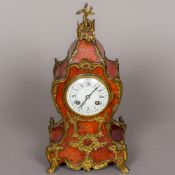 A 19th century ormolu mounted tortoiseshell mantel clock The white enamelled dial with twin