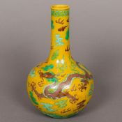 A Chinese porcelain bottle vase Decorated in the round with a five clawed dragon chasing a flaming