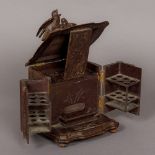 A late 19th century Black Forest carved wooden smoker's cabinet Of hinged form,