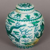 A Chinese porcelain famille verte ginger jar and cover Decorated in the round with dragons chasing