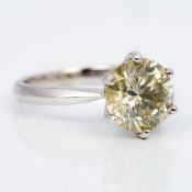 A platinum and diamond solitaire ring The claw set stone approximately 3.4 carats. 1.1 cm high.