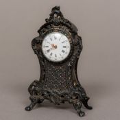 A small Continental silver desk clock Of pierced scrolling foliate design,