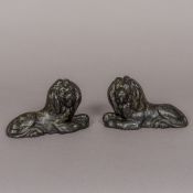 A pair of 19th century cast iron mantel ornaments Each modelled as a recumbent lion.