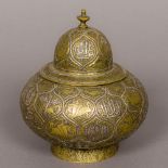 An antique Islamic unmarked silver inlaid brass jar and cover Of squat ovoid form,