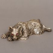 A Russian silver bear Naturalistically modelled in recumbent position,