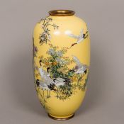 A late 19th/early 20th century Japanese cloisonne vase Decorated with cranes amongst blossoming