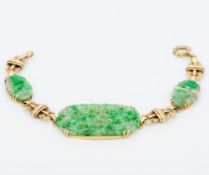 A Chinese unmarked gold and jade bracelet Set with three pierced jade panels. 18 cm long.