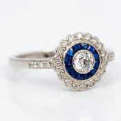 An 18 ct white gold diamond and sapphire ring Of target form. 1 cm high.