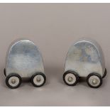 A pair of 1960s polished aluminium cruets Each wheeled, one inscribed Salt 4 Me,