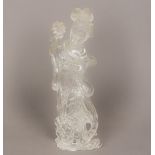 A large Chinese rock crystal carving of Guanyin Typically modelled, holding a flower in a vase. 26.