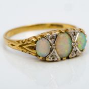 A 9 ct gold opal and diamond ring Of navette form with engraved shoulders. 7mm high.