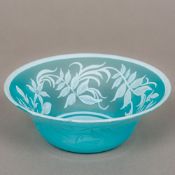 A cameo glass bowl Of flared form, the blue ground with white trailing foliate decoration.