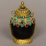 A Tibetan hardstone snuff bottle The gilt metal mounts set with turquoise and other stones.