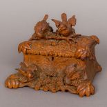 A late 19th century Black Forest carved wooden jewellery casket Of naturalistic form,