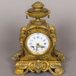 A 19th century French bronze and ormolu mantel clock The white enamel dial with twin winding