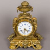 A 19th century French bronze and ormolu mantel clock The white enamel dial with twin winding