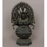 A patinated bronze figure of a multi-armed deity Modelled at prayer in the lotus position,