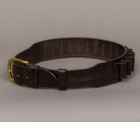 A Purdy lady's leather 12 gauge cartridge belt Of typical form with brass buckle. Size: small.