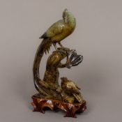 A Chinese carved jade animalier group Formed as two birds perched on a rocky outcrop,