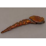 A Chinese carved wooden ruyi sceptre Of pierced carved fruiting form. 25 cm long.