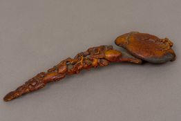 A Chinese carved wooden ruyi sceptre Of pierced carved fruiting form. 25 cm long.
