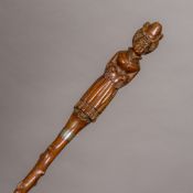 A 19th century carved wooden walking stick The handle formed as an elegant lady,