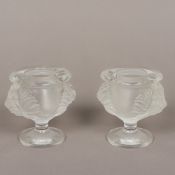 A pair of small Lalique frosted glass vases Each with twin lions masks, standing on a pedestal foot,