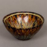 A Chinese Song dynasty type pottery drip glaze bowl Of inverted conical form, with mottled glaze.