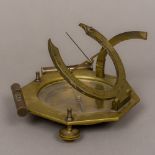 A brass cased compass Set with spirit levels and engraved for various European cities. 15 cm wide.