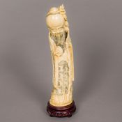 A 19th century Chinese carved ivory figure of Shao Loa Typically modelled holding a staff and peach,