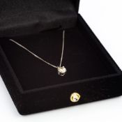 An 18 ct white gold diamond set pendant on chain Set with a single stone approximately 0.3 carat.