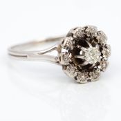 An 18 ct white gold diamond cluster ring 1 cm high.