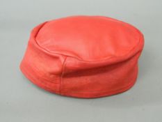 A red leather smoking cap A label to the interior for Herbert Johnson, 30 New Bond Street,