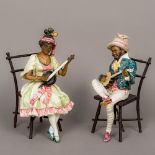 A pair of Goldscheider type porcelain figures Each modelled as a Negro musician, one male,