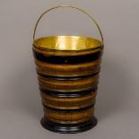 A 19th century Dutch coal bucket Of ebonised form, set with a loop handle and brass liner.