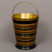 A 19th century Dutch coal bucket Of ebonised form, set with a loop handle and brass liner.