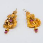 A pair of 19th century unmarked gold diamond and ruby set earrings Of scrolling floral pendant form.