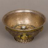 An antique Tibetan unmarked white metal footed bowl The domed interior centred with a pearl,