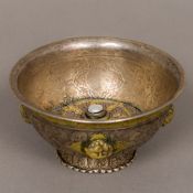 An antique Tibetan unmarked white metal footed bowl The domed interior centred with a pearl,