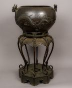 A Meiji period Japanese bronze jardiniere on stand Of ovoid form,