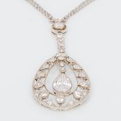 An Edwardian unmarked white gold or platinum diamond set drop pendant on chain The central pear