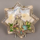 An antique Persian tile Of star form, decorated with a warrior. 30 cm wide.
