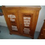 Edwardian oak side cabinet with shelved interior enclosed by two panelled cupboard doors on raised
