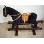 Upholstered modern style rocking horse on wooden swing base